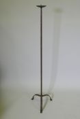 A wrought iron floor standing pricket candlestick, 129cm high