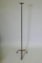 A wrought iron floor standing pricket candlestick, 129cm high