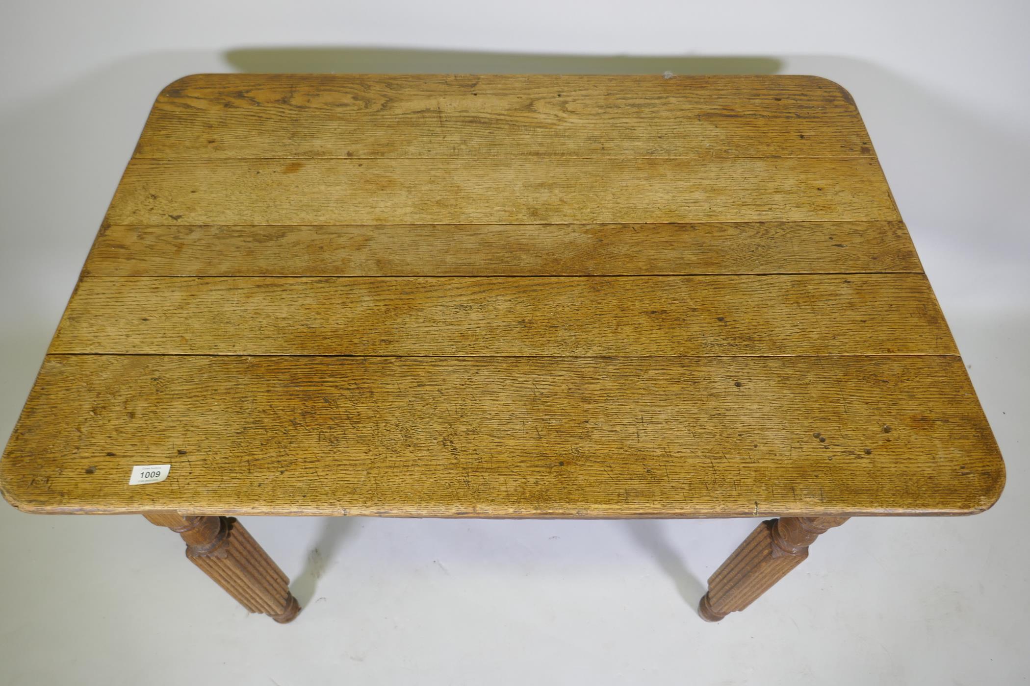 An antique continental oak plank top table, raised on reeded supports, 103 x 74 x 74cm - Image 2 of 3