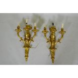 A pair of ormolu Louis XVI style three branch wall sconces, 66cm