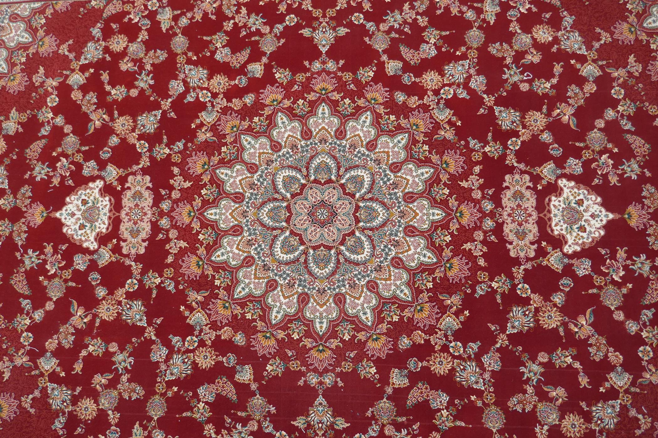 A fine woven full pile rich red ground Qom carpet, with floral medallion design and floral - Image 3 of 5