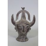 An Eastern bronze head of Saturn with horned headdress, 20cm high