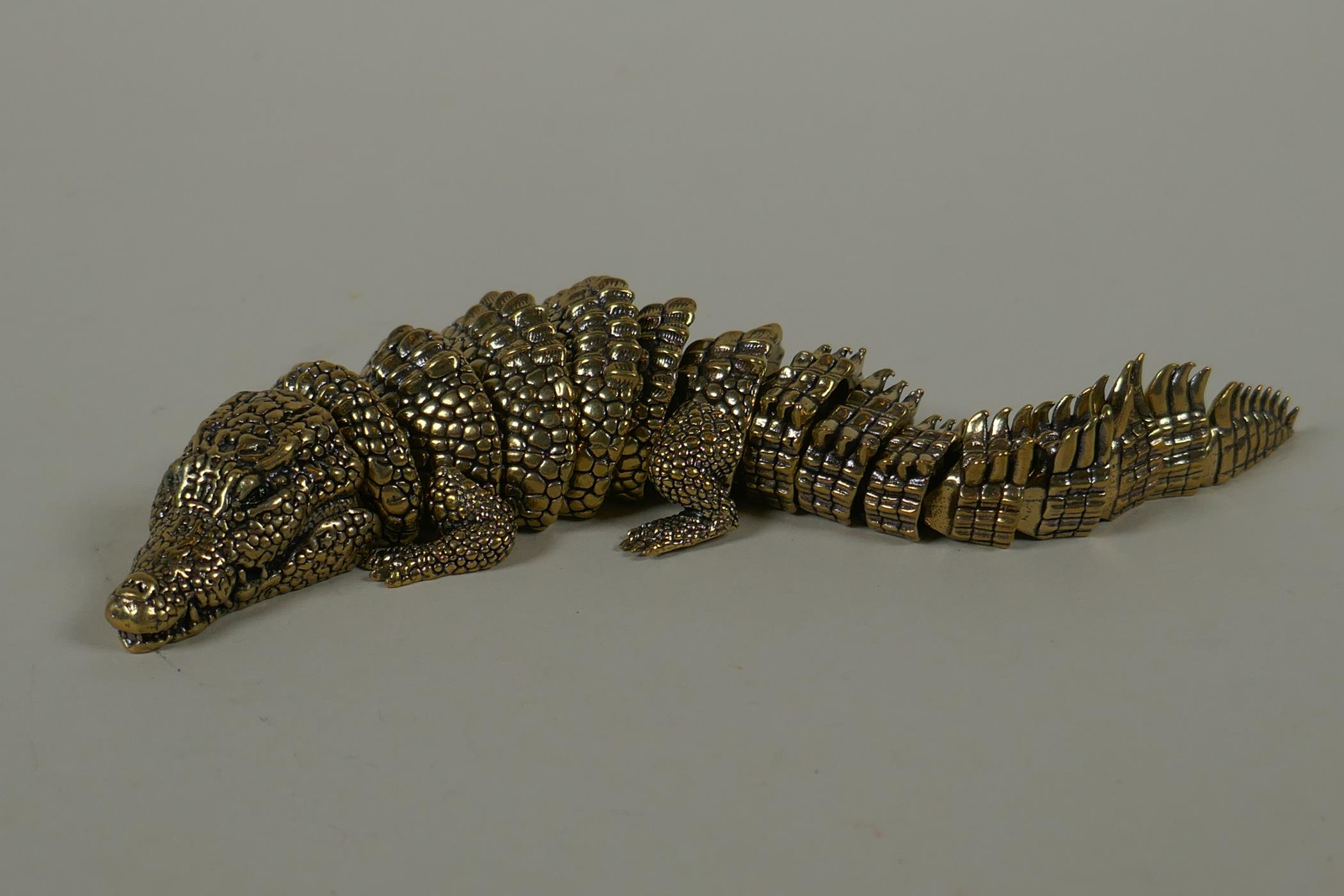 A Japanese Jizai style bronze okimono crocodile with articulated body and legs, 20cm long