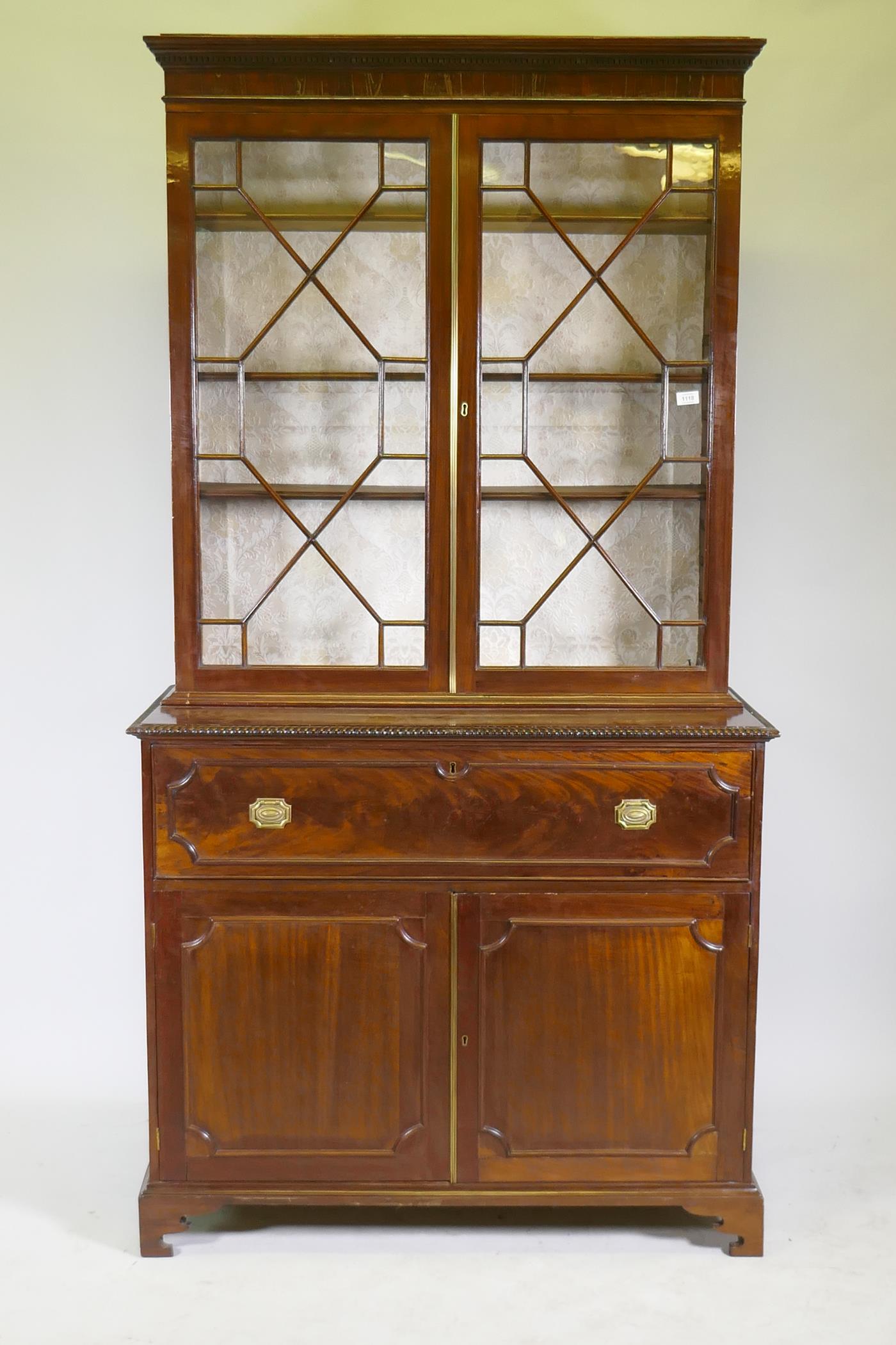 A George III mahogany secretaire bookcase, frieze top and dentil cornice over two astragal glazed