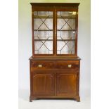 A George III mahogany secretaire bookcase, frieze top and dentil cornice over two astragal glazed