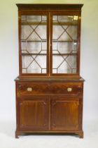 A George III mahogany secretaire bookcase, frieze top and dentil cornice over two astragal glazed