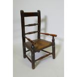 A C19th child's elm spindle back open armchair, 68cm high