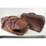 A vintage leather holdall, together with a smaller suitase