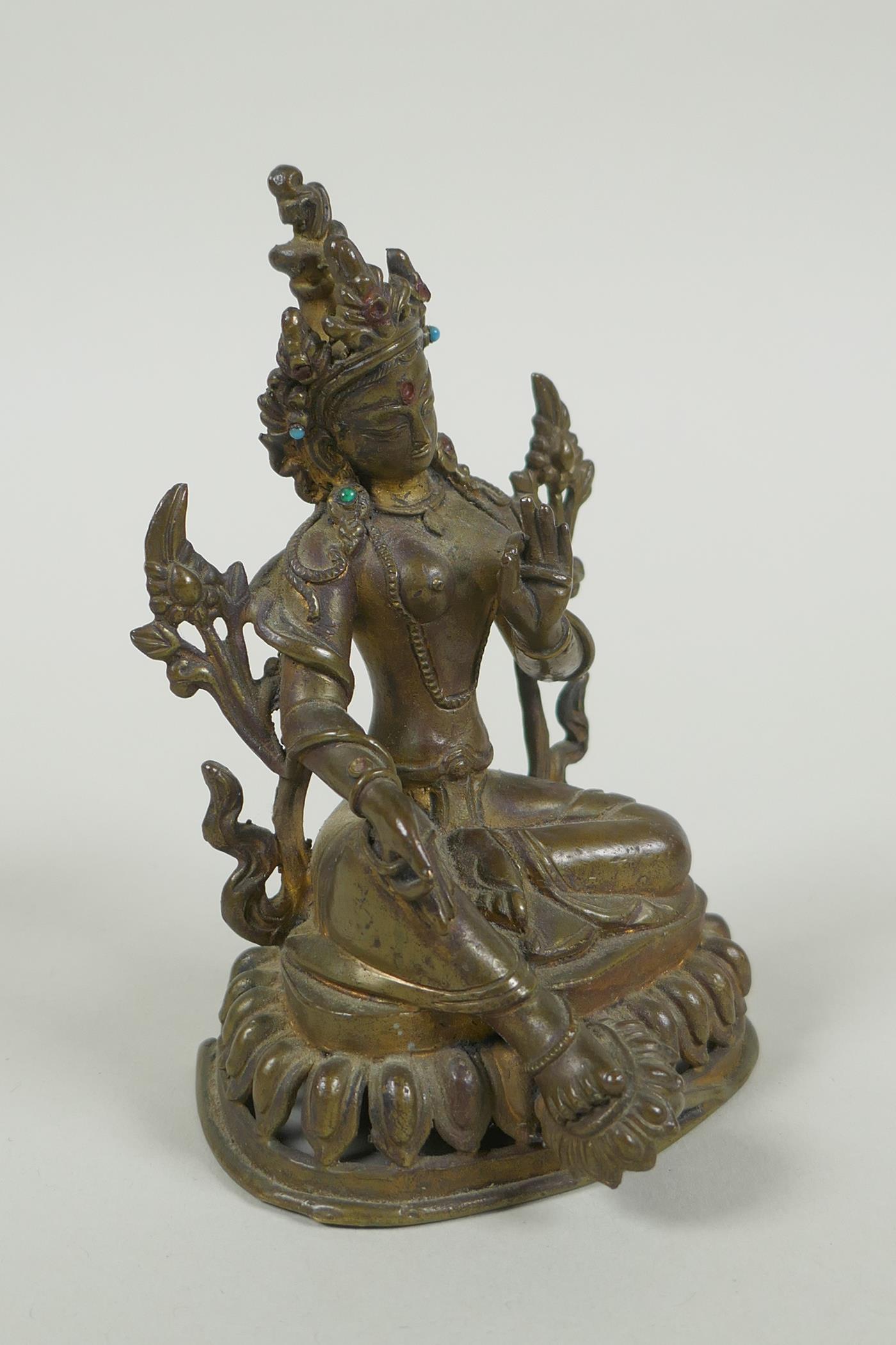 A Tibetan bronze figure of Green Tara with inset turquoise beads, inscription verso, 12cm high - Image 3 of 7