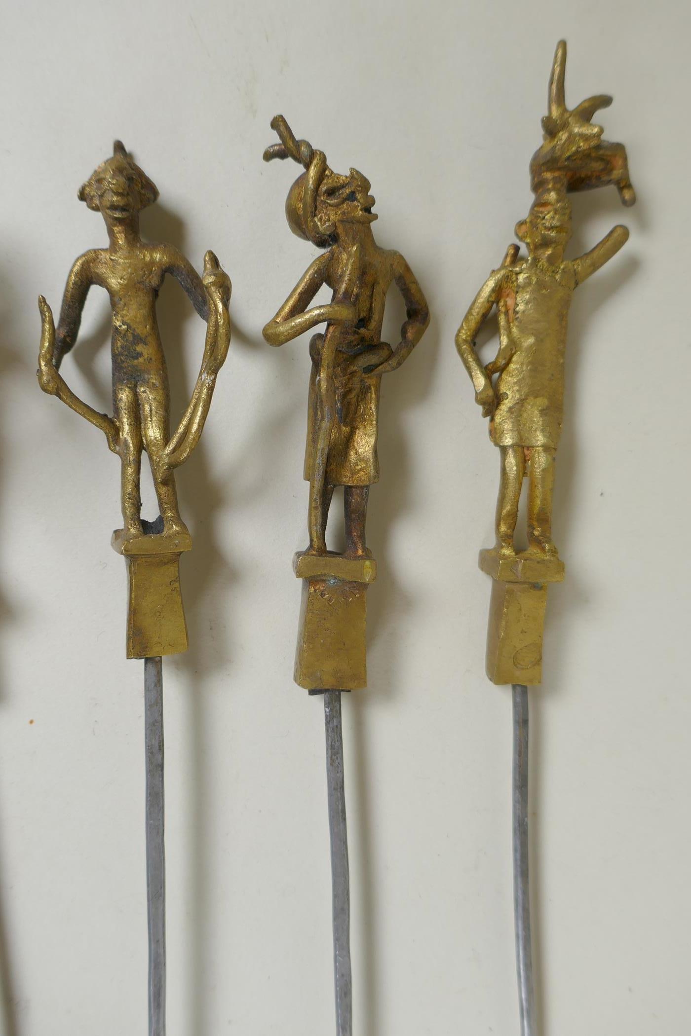 A set of six Indian gilt bronze figural skewers, 50cm long, and a pair of Islamic brass bowls - Image 5 of 6