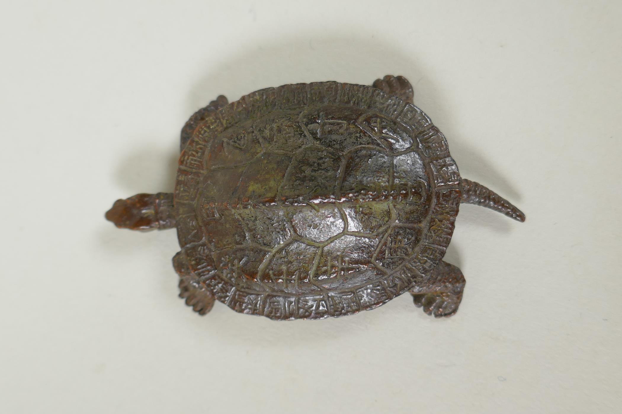 A Japane4se style bronze okimono tortoise, the shell with character inscriptions, 7cm long - Image 2 of 3