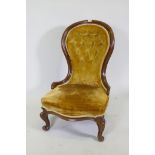 A Victorian mahogany nursing chair with button back and cabriole supports