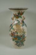 A Japanese Meiji Satsuma vase, with twin mask handles, decorated with a phoenix in flight, 48cm high