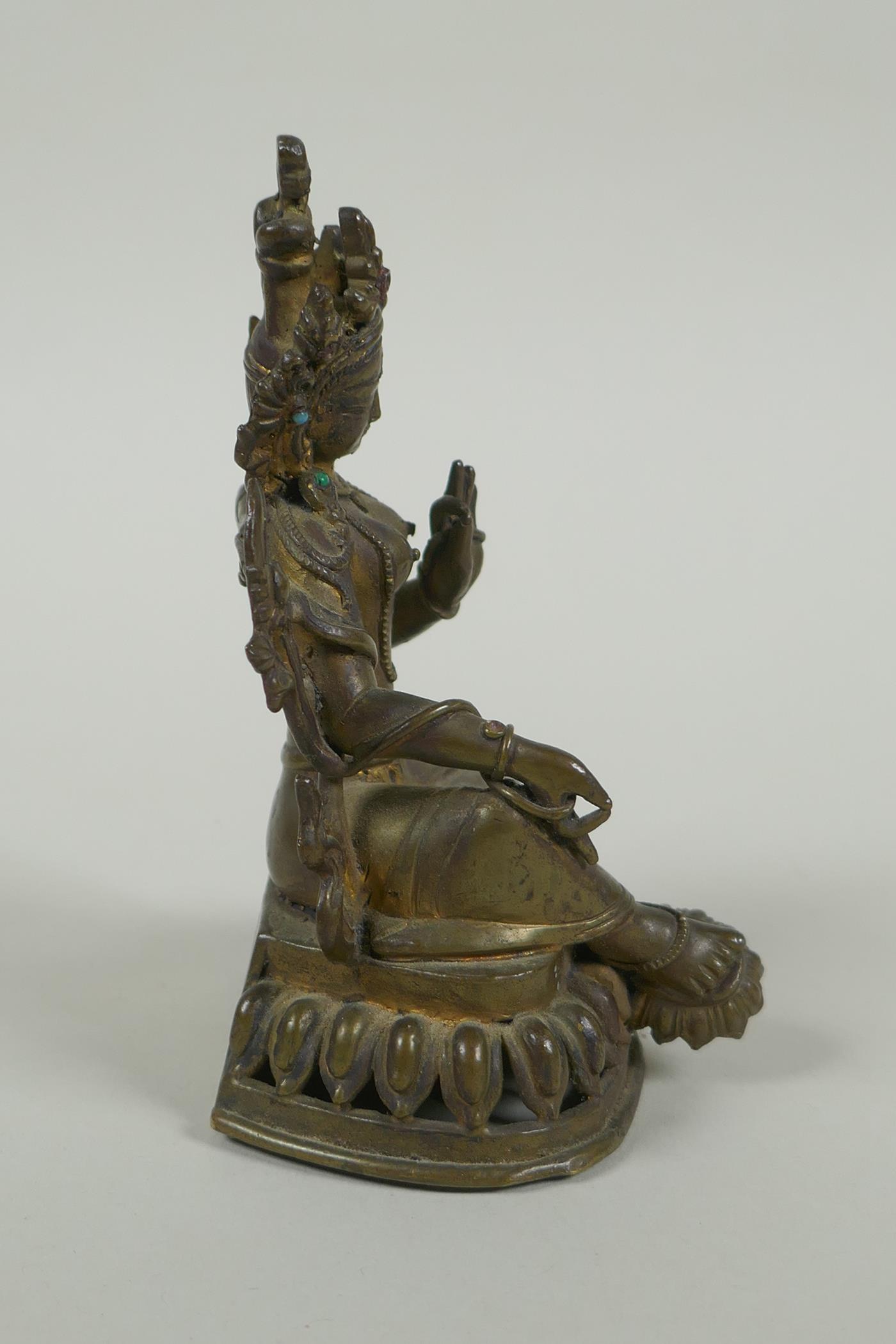 A Tibetan bronze figure of Green Tara with inset turquoise beads, inscription verso, 12cm high - Image 4 of 7