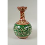 An antique Islamic redware vase decorated with flowers and rodents, chips to glaze, 27cm high