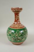 An antique Islamic redware vase decorated with flowers and rodents, chips to glaze, 27cm high