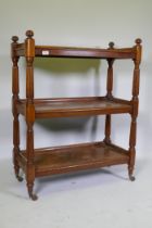 A Victorian mahogany three tier buffet, raised on reeded supports in the manner of Gillows, 89 x