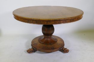 A C19th rosewood tilt top breakfast table, raised on a shaped column with carved detail and platform