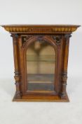 A walnut polyphon case, with pierced spandrels and arched glazed door with apple columns, 62 x 36
