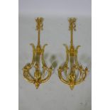 A pair of ormolu empire style five branch wall sconces of lyre form, 97cm high