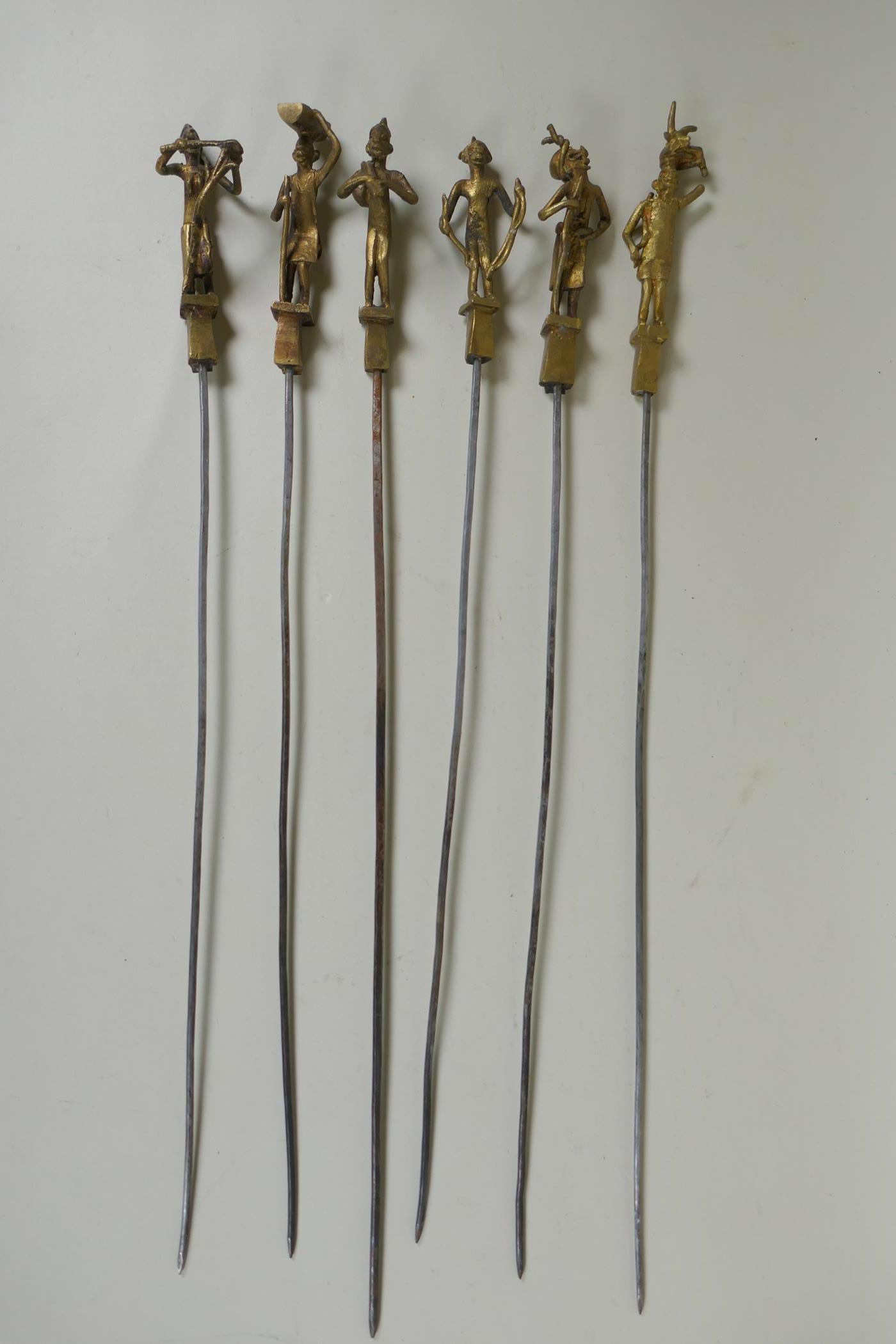 A set of six Indian gilt bronze figural skewers, 50cm long, and a pair of Islamic brass bowls - Image 3 of 6