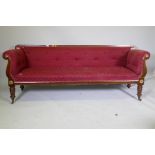 A C19th Continental mahogany settee, with scrolled arms and brass mounts, raised on turned supports,