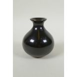 A Chinese treacle glazed porcelain vase of squat form, underglaze marks to the base, 10cm high