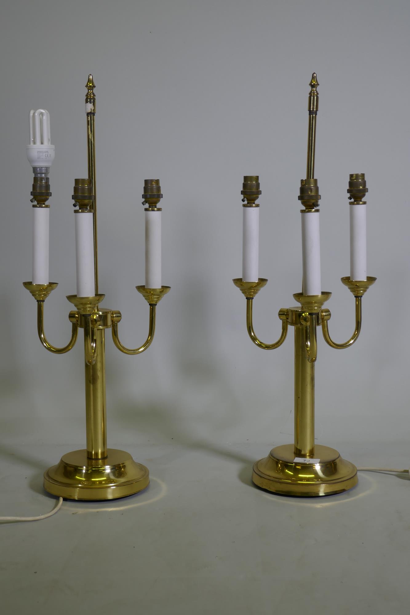 A pair of three branch brass table lamps, 63cm high