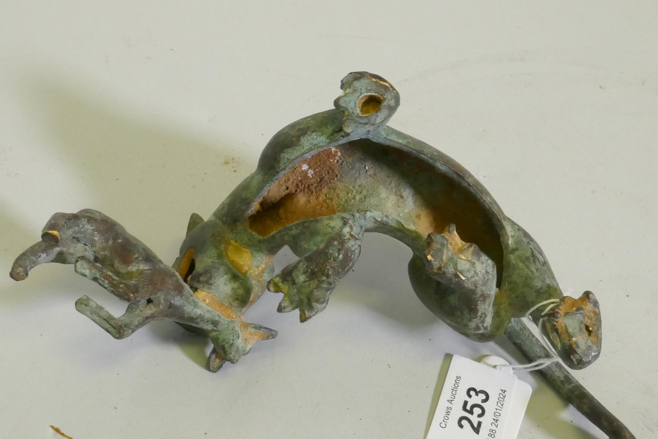 An Eastern bronze figure of a lion with prey, 20 x 7cm high - Image 4 of 4