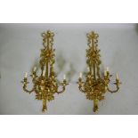 A pair of ormolu five branch sconces decorated with swags, masks and torches etc 119cm