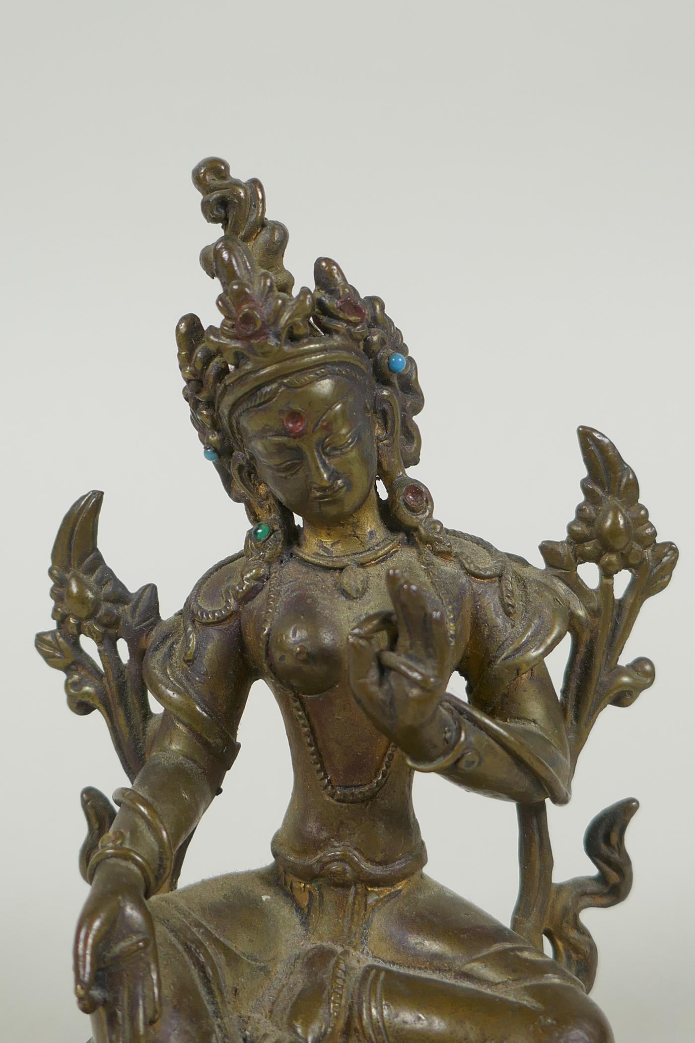 A Tibetan bronze figure of Green Tara with inset turquoise beads, inscription verso, 12cm high - Image 2 of 7