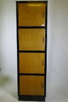 A bespoke mid-century cherry wood and black lacquer media cabinet of four cupboards, 56 x 49 x 193cm