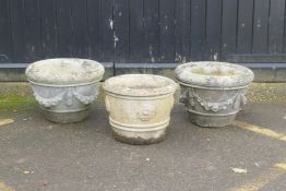 A pair of concrete garden planters, 50 x 36cm, and another
