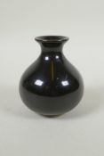 A Chinese treacle glazed porcelain vase of squat form, underglaze marks to the base, 10cm high