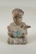 A C19th carved and painted wood figure of a girl carrying a duck, with inset bone eyes, 21cm high