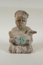 A C19th carved and painted wood figure of a girl carrying a duck, with inset bone eyes, 21cm high