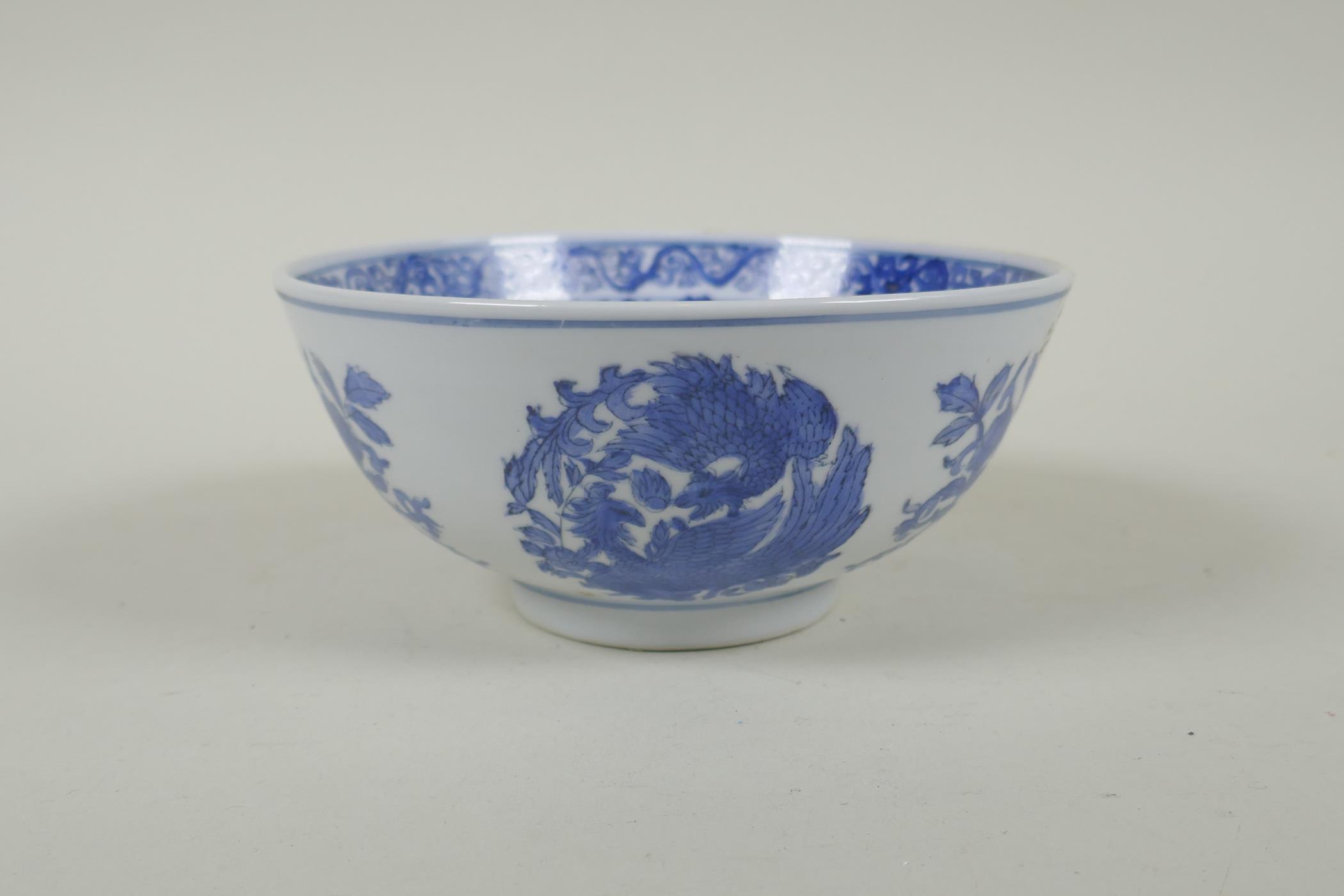 A Chinese blue and white porcelain bowl with phoenix and floral decoration, Qianlong 6 character