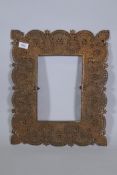 An Indian copper mirror frame with pierced and engraved decoration