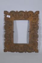 An Indian copper mirror frame with pierced and engraved decoration