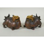 A pair of Chinese filled bronze kylin with gilt heads, 11cm long