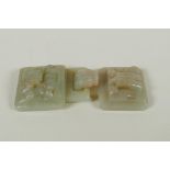 A Chinese carved celadon jade belt buckle with dragon and phoenix decoration