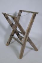 A rustic weathered wood baggage stand, 70cm high