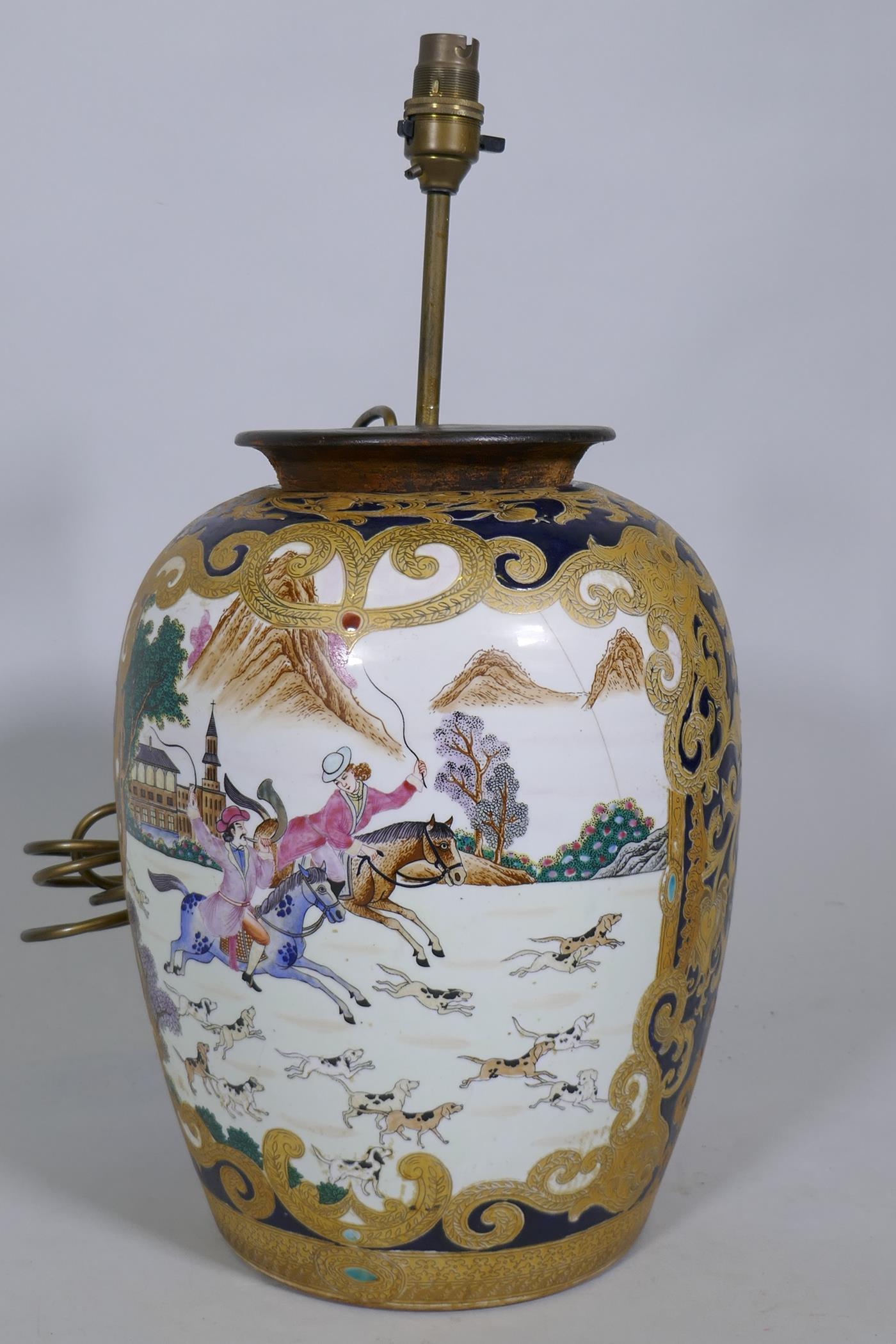 A Chinese export ceramic lamp, decorated with a hunting scene, 50cm high