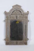 A Victorian Renaissance Revival cast iron framed wall mirror with lion mask decoration, and original