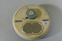 A Decca Model TPW70 MW/LW transistor radio, 26cm diameter