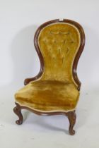 A Victorian mahogany nursing chair with button back and cabriole supports