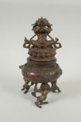 A Tibetan gilt bronze censer and cover, the knop in the form of a wrathful deity, double vajra