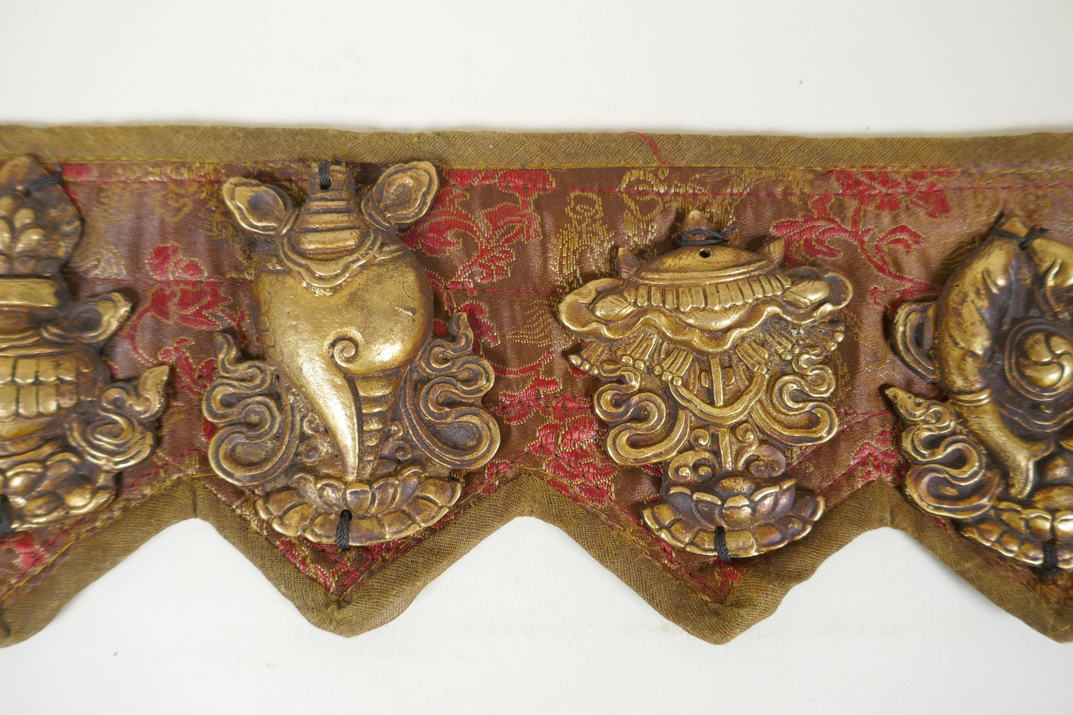 A Tibetan silk and linen belt with bronze mounts depicting the eight Buddhist treasures, 72cm long - Image 3 of 5