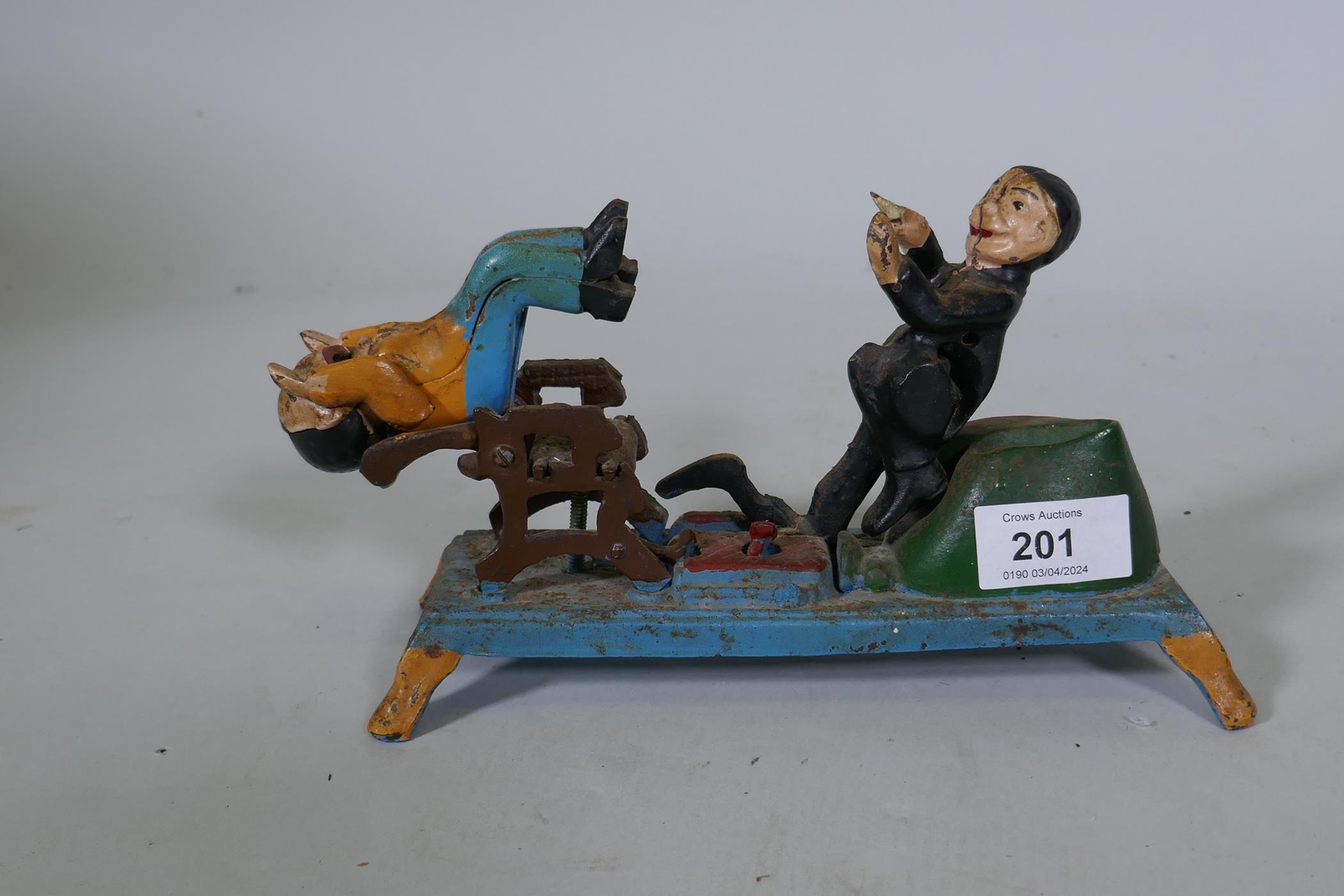 A painted cast iron money box in the form of a dentist, 22cm long, 16cm high - Image 2 of 3