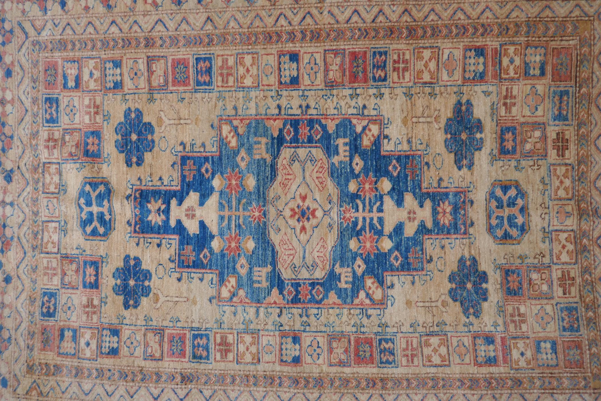 A Turkish gold ground wool rug with a blue geometric medallion design, 164 x 212cm - Image 2 of 4